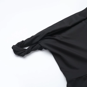 Detailed view of the shoulder knot design on this slim black one-shoulder jumpsuit