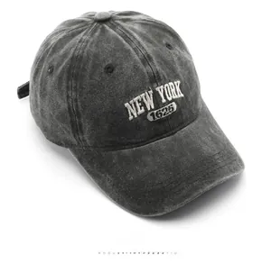 Detail of vintage washed charcoal denim cap with 3D white New York embroidery