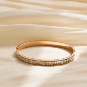 Macro shot of gold stainless steel bangle set with rectangular cubic zirconia crystals