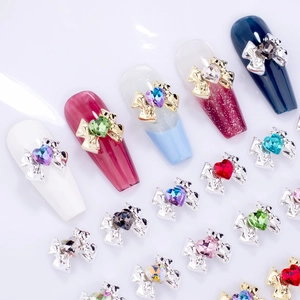 Detail of 3D alloy bow nail charms with colorful heart-shaped rhinestones for DIY manicure