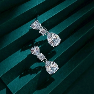 Close-up of S925 silver earrings with heart, round, and pear-shaped cut drop crystals