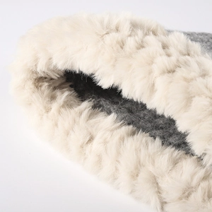 Winter women's warm knitted bucket hat with fluffy faux fur trim and thick gray lining