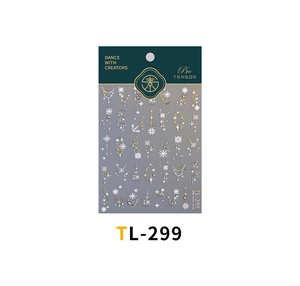 Detailed view of winter nail art stickers with gold and white snowflake patterns