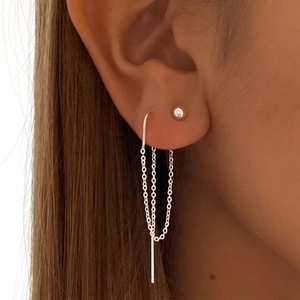 Close-up of S925 sterling silver chain tassel star drop earrings worn by a model