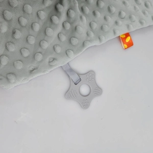 Detail of grey minky dot baby security blanket with star-shaped silicone teether