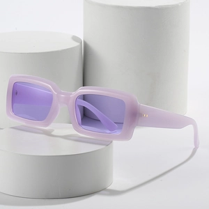 Fashionable square lavender sunglasses with purple translucent lenses on white geometric stands