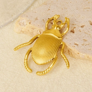 Macro shot of gold beetle pendant with detailed wing textures and top hanging ring