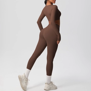 Detail view of chocolate brown high-waist yoga pants and cropped long sleeve fitness set