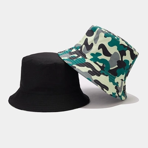 Detail of reversible camouflage and black bucket hats showing durable fabric and stitching