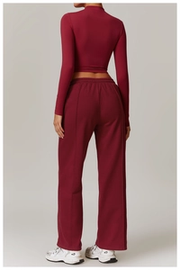Detailed back view of a burgundy long sleeve yoga top and matching wide-leg fitness pants