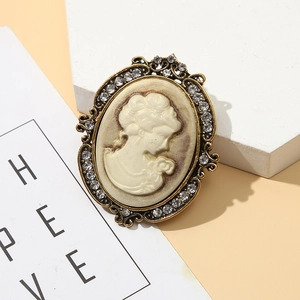 Vintage oval cameo brooch with crystal border and elegant female figure carving
