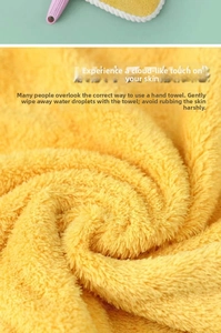 Close-up detail of soft yellow coral fleece hand towel with dense absorbent fibers
