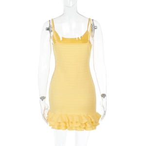 Detail of yellow backless mini dress with smocked fabric and layered ruffle hemline
