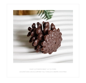 Macro shot of realistic brown artificial pine cone decoration with detailed scale texture