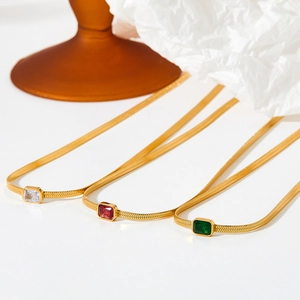 Golden flat snake bracelets with colorful rectangular zircon charms in white, red, and green