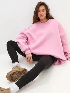 Detailed view of pink oversized sweatshirt with soft fleece lining and loose fit design