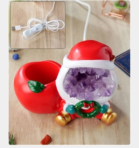 Macro view of Santa night light with amethyst crystal geode and USB power cable