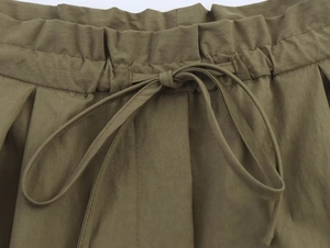 Close-up of olive green elastic waistband with drawstring on casual short pants