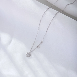 S925 silver hollow heart pendant necklace with zircon stones on white texture