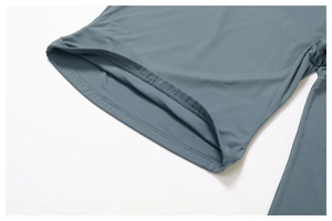 Detail shot of seamless stitching and elastic knit fabric on a dark grey yoga t-shirt