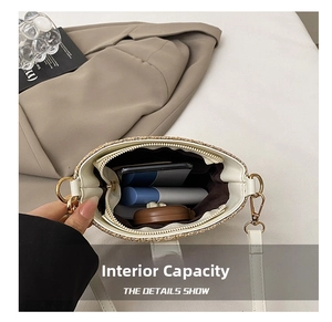 Macro view of woven straw bucket bag interior with zipper pocket and ample capacity
