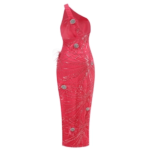 Detail of sequin star patterns and feather accents on a red sleeveless evening gown