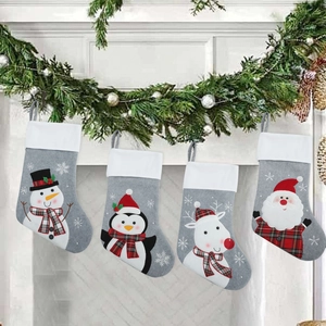 Set of 4 Christmas stockings with snowman penguin reindeer and Santa hanging by fireplace