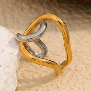 Two-tone intertwined stainless steel ring with 18K gold plating on a stone base