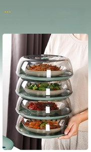 Close-up of four-tier stackable transparent food covers with handles for space saving