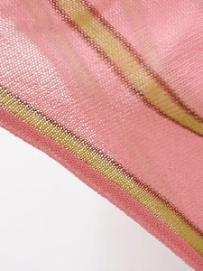 Close-up of pink mesh fabric with green and brown stripes and breathable texture