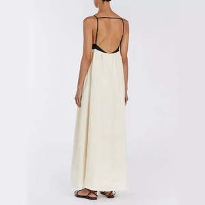 Elegant backless contrast maxi dress with black straps and creamy white satin drape