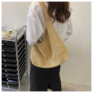 Detail of hollow woven shoulder bag featuring premium beige knit and PU leather strap