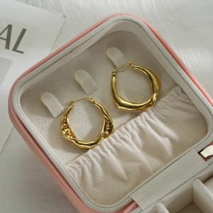 Exaggerated golden stainless steel twisted hoop earrings in a pink jewelry gift box