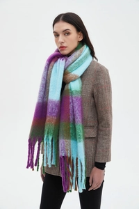 Detail of colorful plaid scarf with fringes and plush texture on model's shoulder