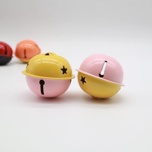 Close-up of 4cm bicolor metal bells with star cutouts for crafts and keychains