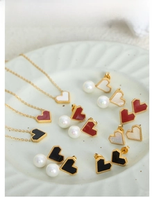 Macro view of heart-shaped shell jewelry set with milgrain edges in 18K gold plating