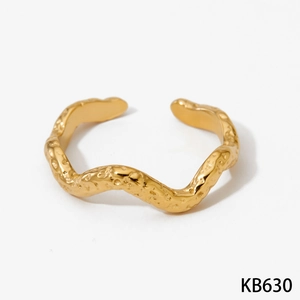 Detailed view of golden wave ring featuring unique hammered texture and adjustable band