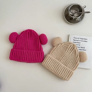 Winter knitted hats for kids featuring cute double ball ears and warm ribbed texture