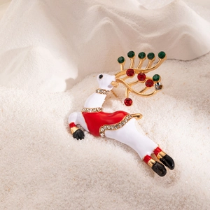 Macro detail of Christmas reindeer brooch with white enamel, red crystals, and gold antlers
