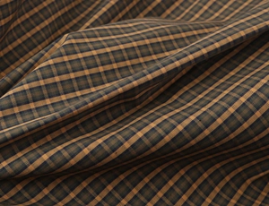 Close-up of plaid cotton shirt fabric with detailed fiber texture and vintage check pattern