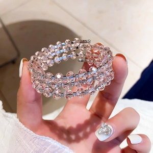 Detail of champagne crystal beaded triple layer wrap bracelet with glittering metal spacers