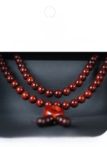Macro view of Lobular Red Sandalwood beads showing golden star texture and ox-hair vein