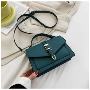 Detail of dark green PU leather crossbody bag with metal buckle and adjustable strap