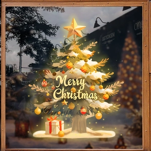 Golden Christmas tree glass sticker with snow, gifts, and glowing star for festive windows