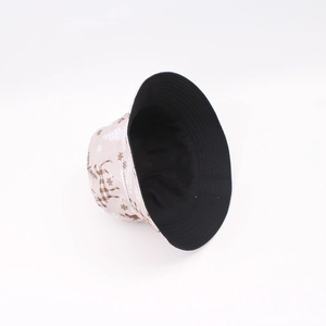 Detail view of beige Christmas bucket hat with reindeer patterns and Merry Christmas text