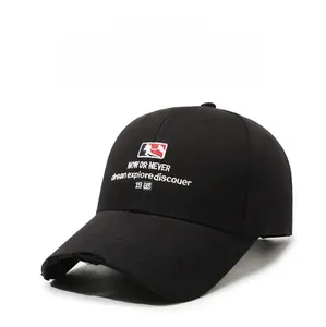 Close-up of black cotton baseball cap with distressed brim and high-quality letter embroidery