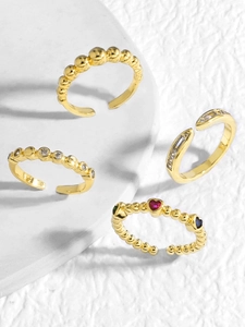 Detailed view of four 18K gold-plated adjustable rings with colorful zircon heart stones