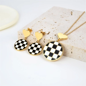 Golden necklace and heart earring set with black and white checkerboard pattern