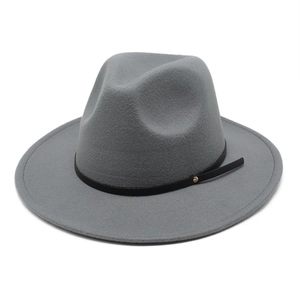 Macro detail of the grey wool fedora hat with a black leather band and gold stud