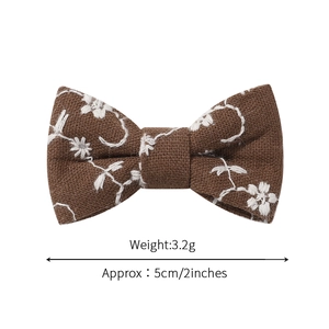 Brown embroidered linen bow hair clip for children with white floral patterns